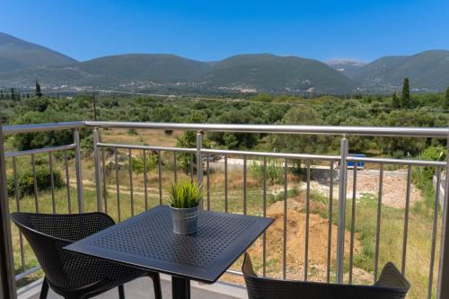 a table and chairs on a balcony with mountains at Maera Apartments in Sami