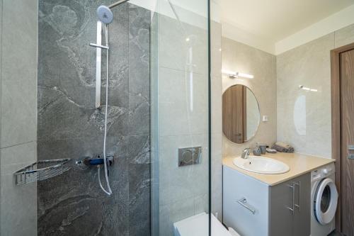 a bathroom with a shower with a toilet and a sink at Maera Apartments in Sami