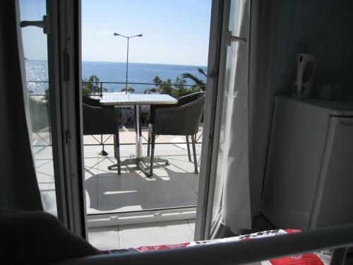 a view of a patio with a table and chairs at Cavo Christo in Petra