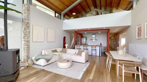 a living room with a white couch and a table at The Cliffs - OceanLight 
