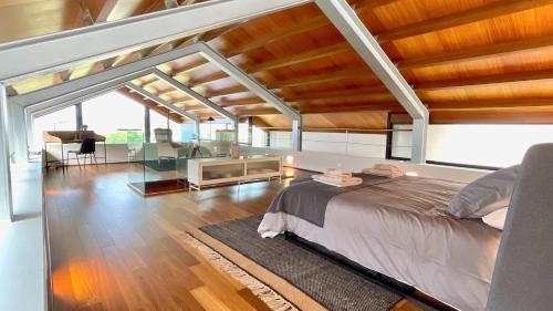 a bedroom with a large bed and a living room at The Cliffs - OceanLight 