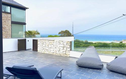 a patio with a view of the ocean from a house at The Cliffs - OceanLight 