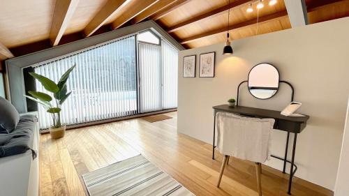 a room with a table and a mirror and a couch at The Cliffs - OceanLight 