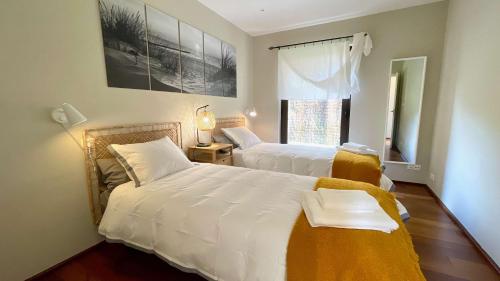 a bedroom with two beds and a window at The Cliffs - OceanLight 