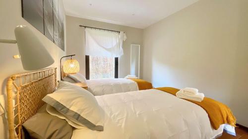 a bedroom with two beds and a window at The Cliffs - OceanLight 