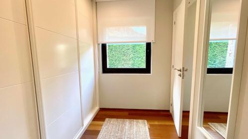 an empty hallway with a door and a window at The Cliffs - OceanLight 