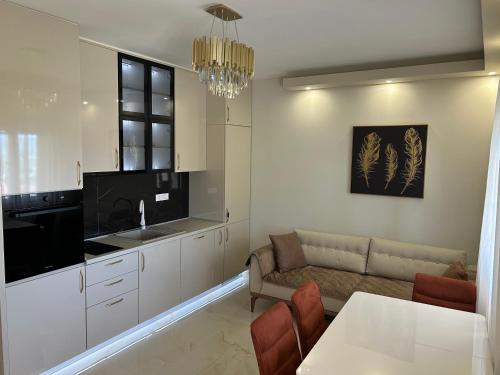 a kitchen and living room with a couch and a table at Vista Boka New Luxury Apartment in Kotor in Kotor