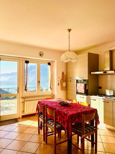 a kitchen with a table with a red table cloth at Le Palm House has two bedrooms with the breathtaking view over lake Como in Perledo