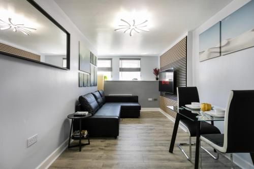 a living room with a couch and a table at Luxury Retreat in the Heart of Leicester City Centre! in Leicester
