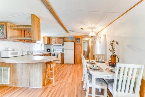 a kitchen with wooden cabinets and a table and chairs at 2 Mi to Ellenton Outlets Home with Community Perks! in Ellenton