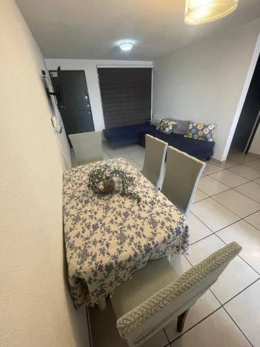 a room with a table and chairs with a floral table cloth at Depa a pasos del Autódromo in Mexico City