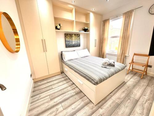 a small bedroom with a bed and a window at 93 A Apartment in London