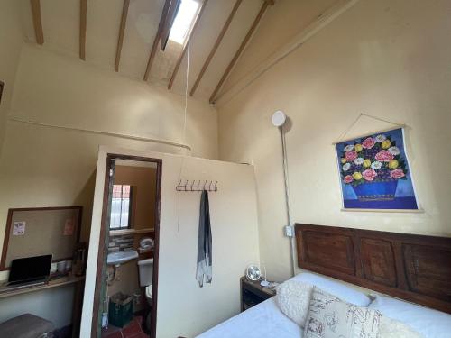 a bedroom with a bed and a painting on the wall at Colivingranada in Envigado