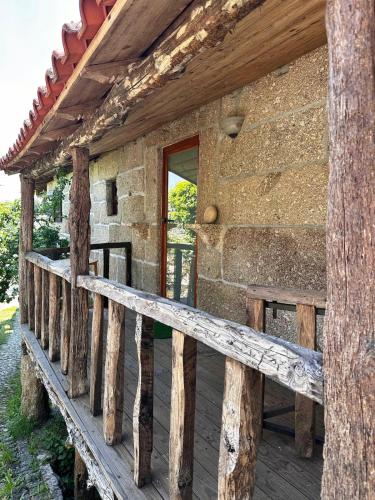 a wooden porch of a log cabin with a window at Casa do Arte - Peaceful Retreat with a Pool near Guimarães in São Torcato