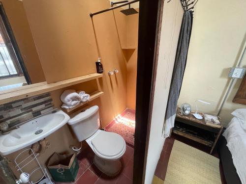 a small bathroom with a toilet and a sink at Colivingranada in Envigado
