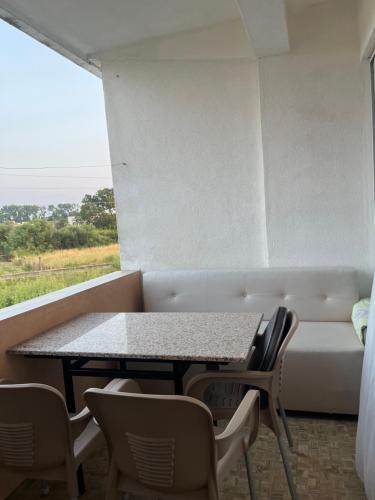 a table and chairs in a room with a couch at Apartments Murati in Ulcinj