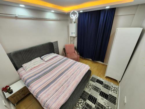 a small bedroom with a bed and a chair at Q Apart Daire 6 in Eskisehir