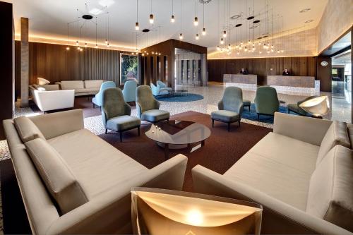 a lobby with couches and chairs and a bar at Palace Bonanza Playa Resort & SPA by Olivia Hotels Collection in Illetas