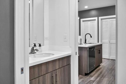 a white kitchen with a sink and a counter at The Well #203 in Zephyrhills