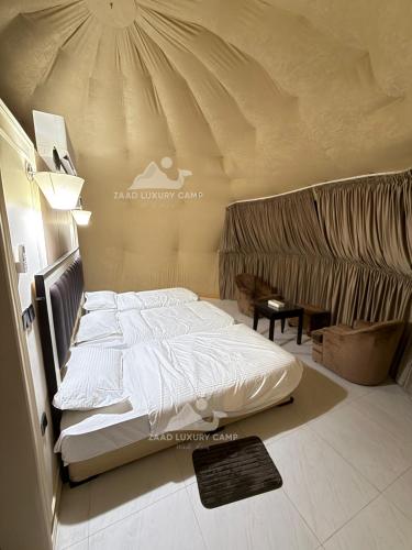 a bedroom with a large bed in a tent at Wadi Rum ZAAD luxury Camp in Disah