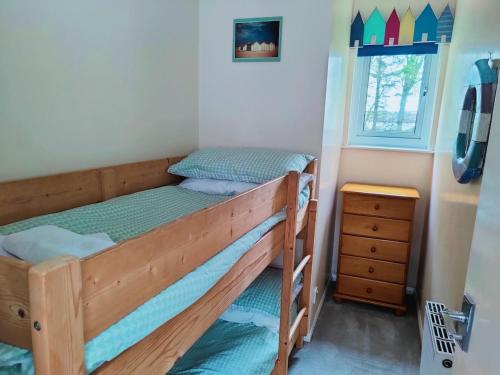 a bedroom with two bunk beds and a window at Little Croft, woodland setting sleeps 2 plus 2 kids near Perranporth in Perranzabuloe