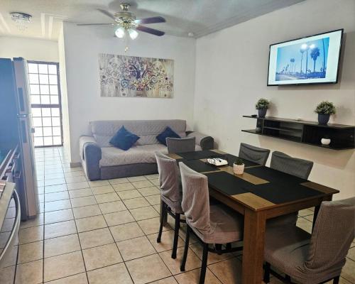 a living room with a table and a couch at Flor del desierto in La Paz