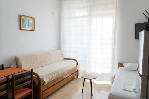a living room with a couch and a table at Parid Appartments in Sarandë