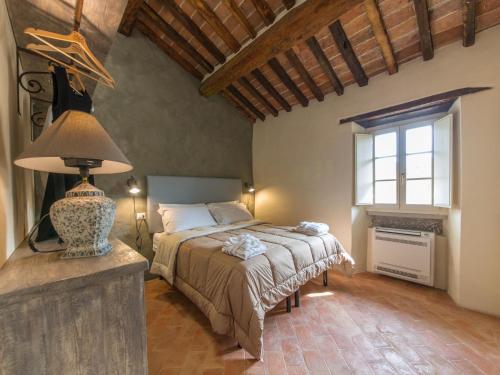 a bedroom with a bed and a large window at Casa Zeni in Cortona