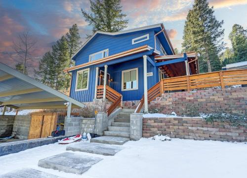 a blue house with snow in front of it at Cobalt Peak - Pet-Friendly Sauna Panoramic Views in Cascade-Chipita Park