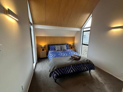 a bedroom with a bed in a small room at Airport Retreat 4 Bedrooms 8 Guests in Christchurch