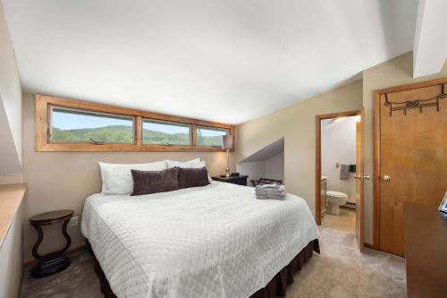 a bedroom with a large bed and a window at Walk to Lift Across from Holiday Valley AC in Ellicottville