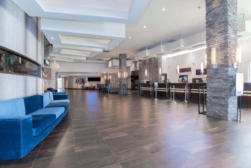 a lobby with a blue couch in the middle of a room at Sandman Signature Vancouver Airport Hotel & Resort in Richmond