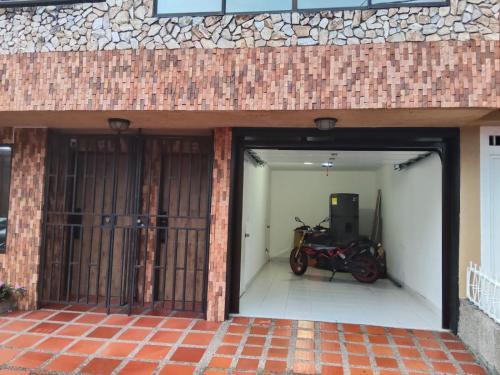 a motorcycle parked inside of a garage at Glam House Hotel in Medellín