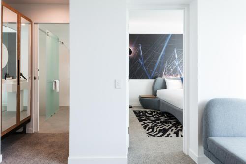 two views of a living room and a bedroom at Novotel Brisbane South Bank in Brisbane