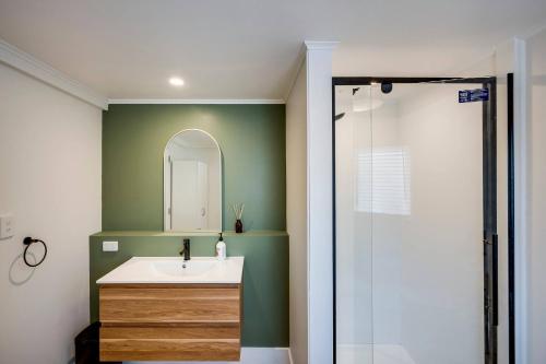 a bathroom with a sink and a shower at Cabbage Tree Corner in Napier