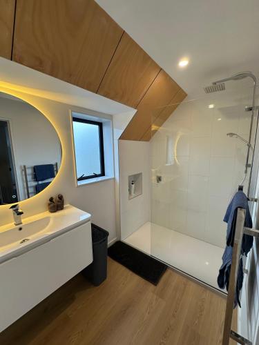 a bathroom with a large shower and a sink at Airport Retreat 4 Bedrooms 8 Guests in Christchurch