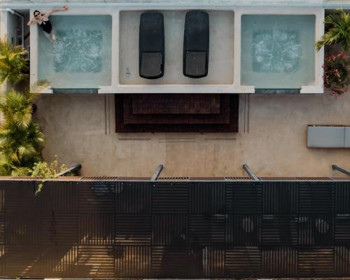 a person jumping out of a window of a building at Kahal Hotel - Paseo Montejo in Mérida