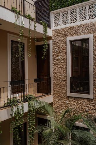 a building with plants on the side of it at Kahal Hotel - Paseo Montejo in Mérida
