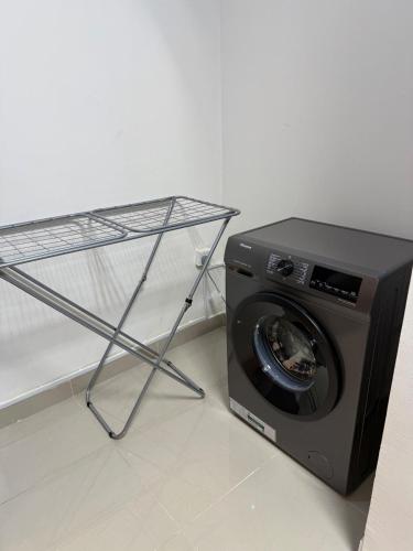 a washing machine sitting next to a microwave at Brand new - Stylish Studio Near to Yas & Airport in Abu Dhabi