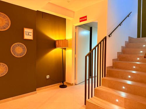 a hallway with stairs and a lamp in a building at dozZze - Madrid Río in Madrid