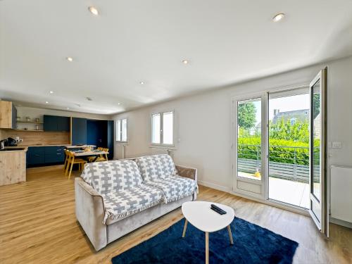 un salon avec un canapé et une table dans l'établissement Le Céleste - Élégance raffinée - Terrasse - Plages, à Saint-Malo