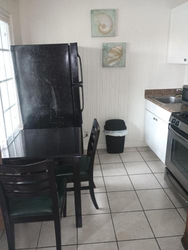 a black chair in a kitchen with a sink at Oceana Boutique Hotel in San Clemente