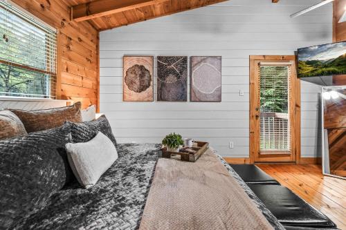 a bedroom with a bed in a room with wooden walls at Willow Creek cabin in Townsend