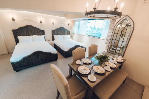 a bedroom with two beds and a table with plates on it at MONTHLIV Euljiro Hotel Stay in Seoul