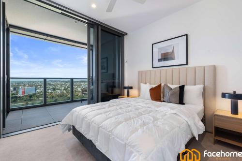 a bedroom with a large bed and a large window at Elevated Luxury at QWR City & River Views in Brisbane