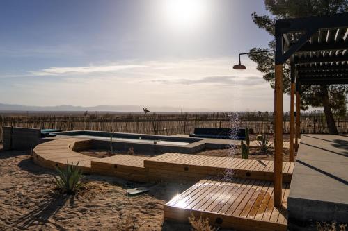 a backyard with a water fountain and a wooden deck at Hi Desert Pool Club in Landers