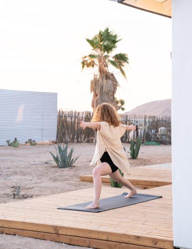 a young girl doing a yoga pose on a yoga mat at Hi Desert Pool Club in Landers