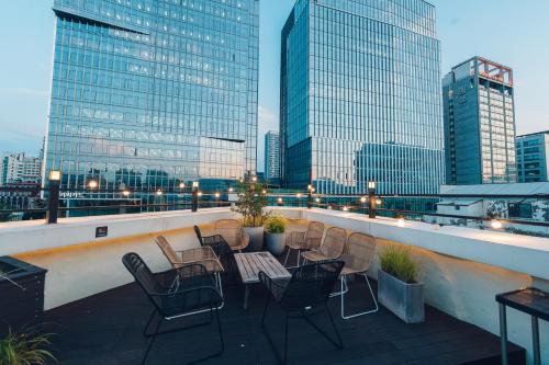 a balcony with chairs and a table on a building at MONTHLIV Euljiro Hotel Stay in Seoul