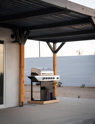 a barbecue grill under awning on a patio at Hi Desert Pool Club in Landers