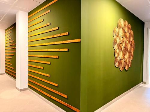 a green wall with wooden dividers in a room at dozZze - Madrid Río in Madrid